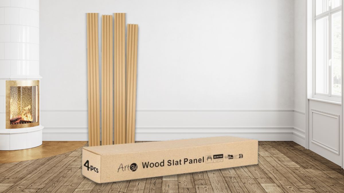 A set of Art3d wood slat panels leans against a white wall in a bright room with wooden flooring, a fireplace, and a box labeled "4pcs Wood Slat Panel" in the foreground.