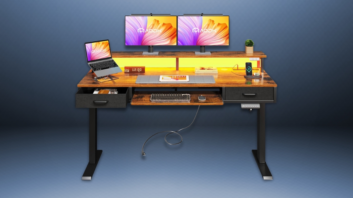 AODK electric standing desk with a wood finish, dual monitors, LED lighting, storage drawers, a keyboard tray, and built-in power outlets for a modern workspace.