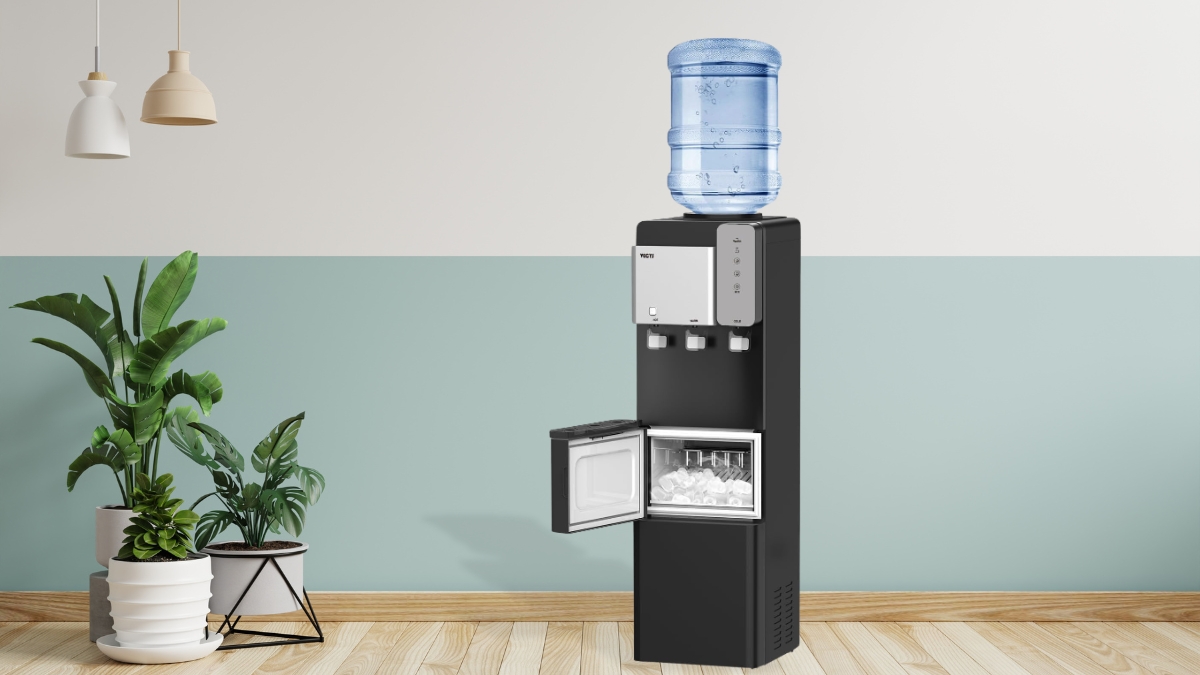 A black water dispenser with ice maker and a 5-gallon water bottle, placed near indoor plants in a modern room.