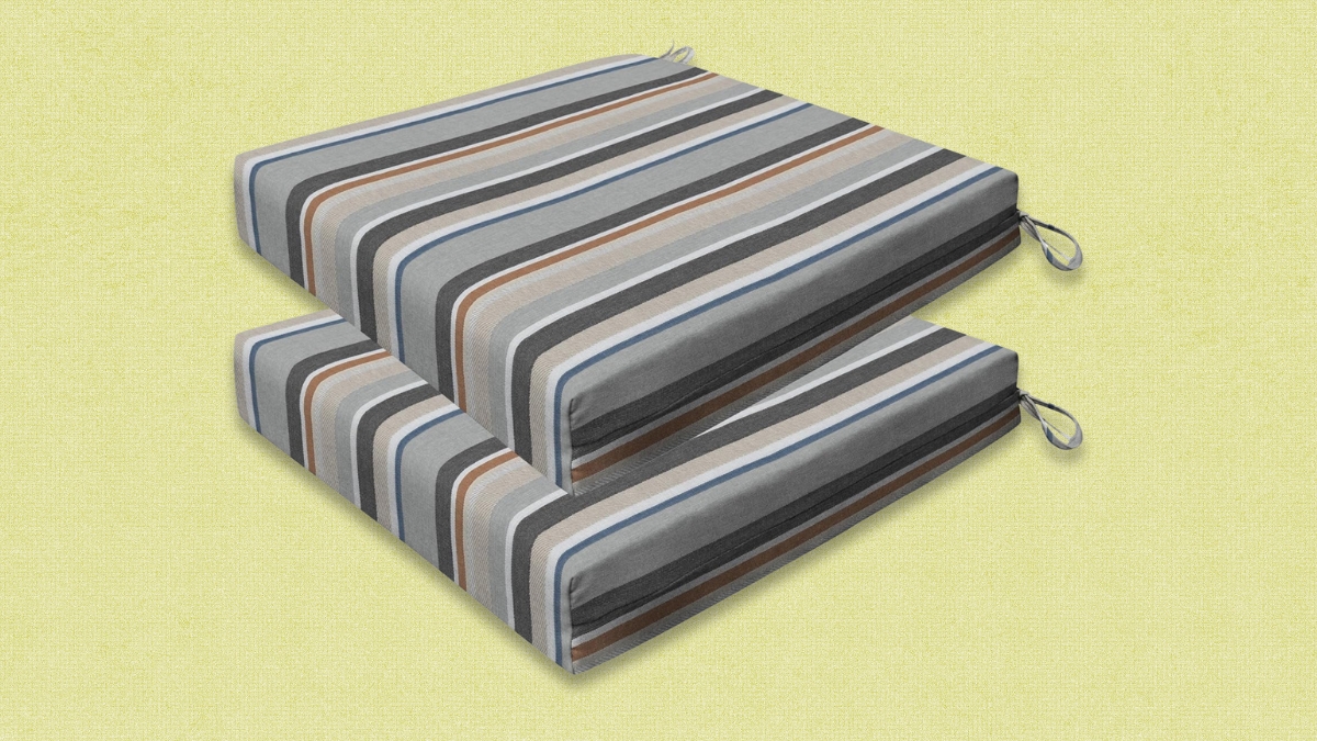 Two striped outdoor dining chair cushions with tie-on straps, featuring shades of gray, blue, brown, and black.