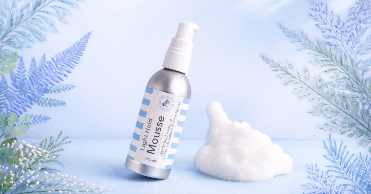 Light hold hair mousse bottle next to airy foam, showing lightweight styling product for soft volume and natural hair texture