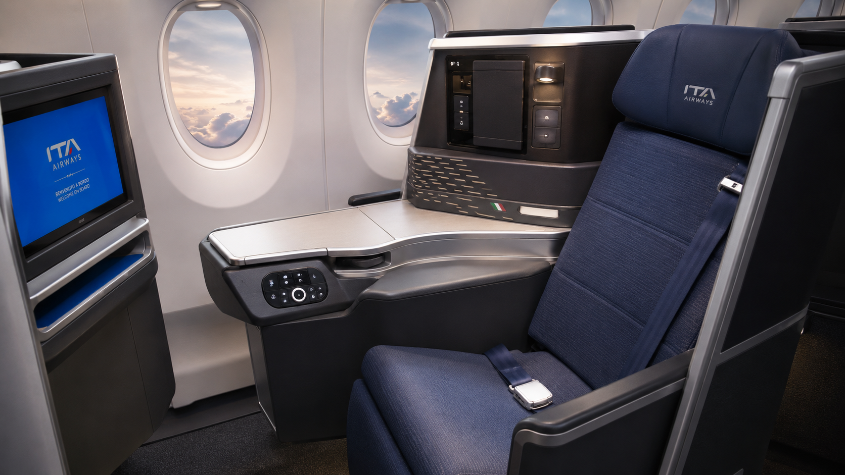 ITA Airways business class cabin on Rome to New York flight featuring modern lie-flat seat, premium Italian design, in-flight entertainment screen, and luxury long-haul travel experience.