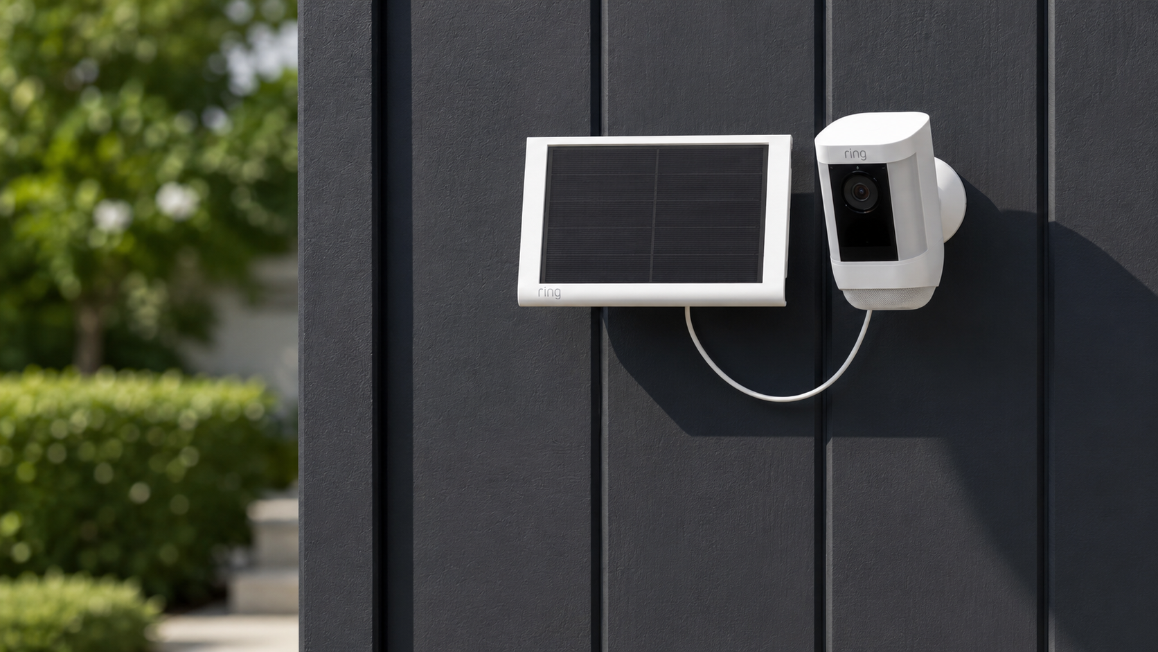 Ring Solar Panel (2nd Generation) mounted outdoors beside Ring security camera in sunlight