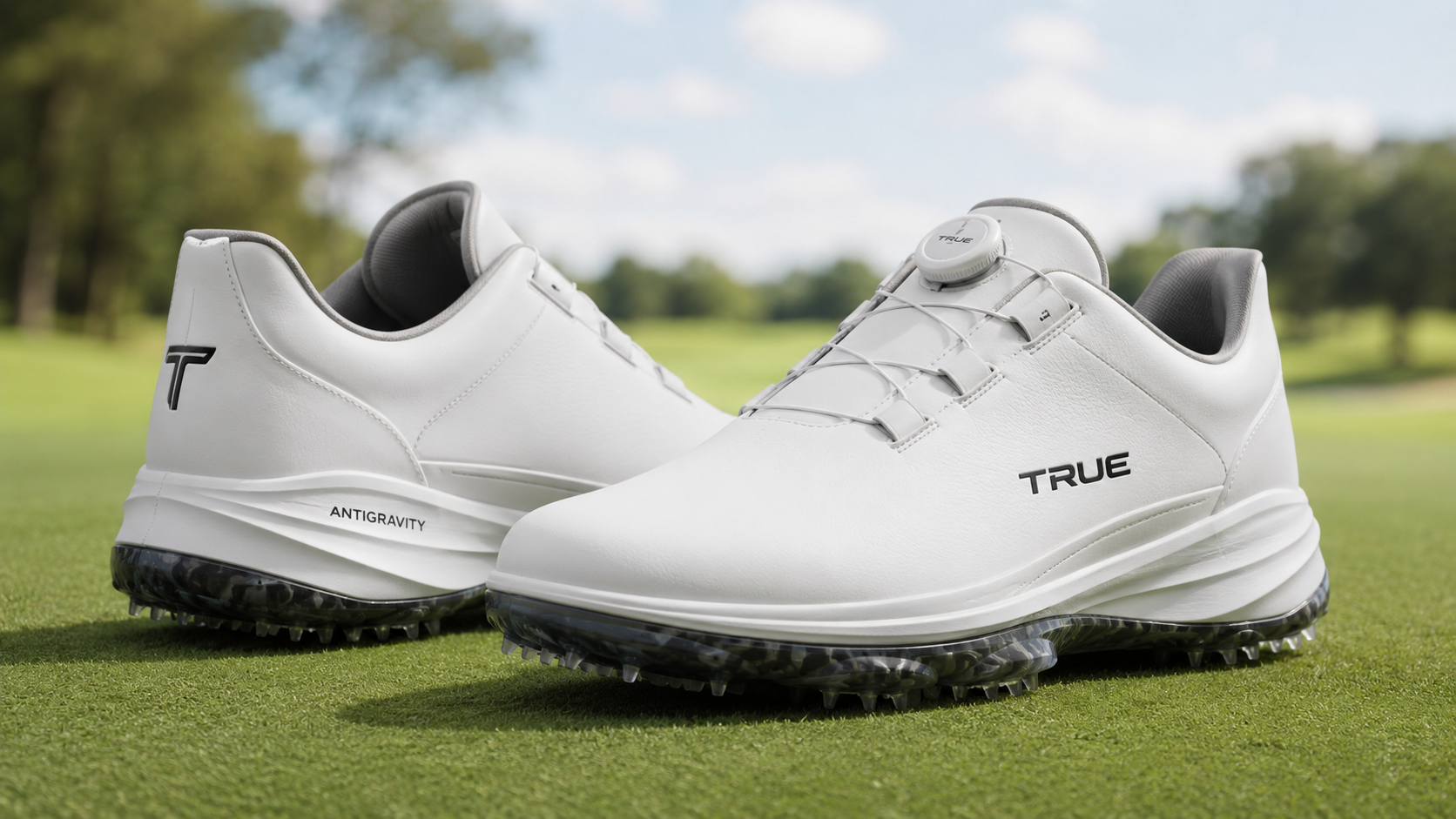 TRUE Antigravity golf shoes in white displayed on a golf course green, featuring a lightweight waterproof design with spikeless traction for enhanced comfort and stability.