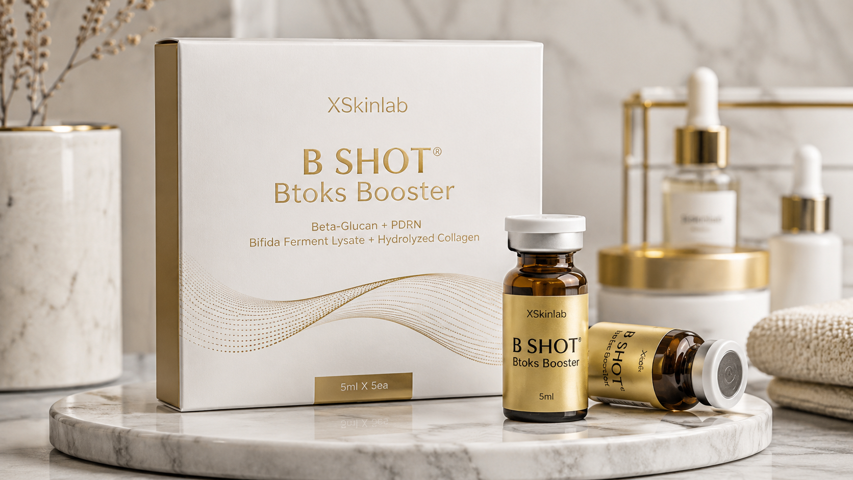 XSkinlab B SHOT® Btoks Booster skincare ampoules and box displayed on a marble vanity, featuring Beta-Glucan, PDRN, Bifida Ferment Lysate, and Hydrolyzed Collagen for anti-aging, skin repair, and hydration.
